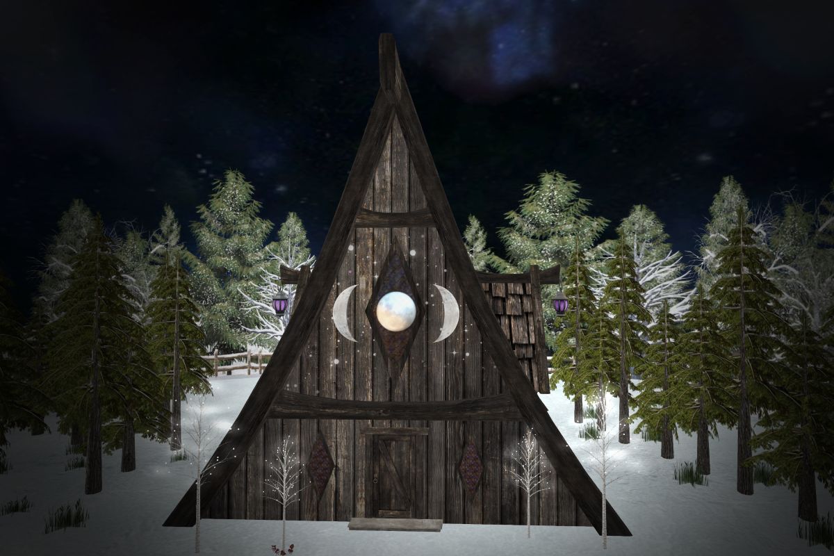 A dark wood A-frame home surrounded by forest and snow